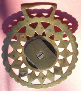 Aftermarket? green pot added to "diamond in a ring of diamonds" stamped brass