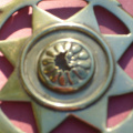 cast star in crescent with insert of stamped flower